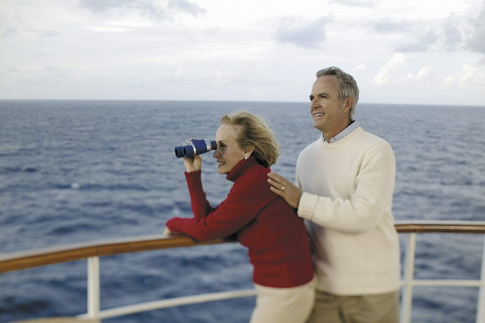 Couple enjoying ocean view on a ship.
