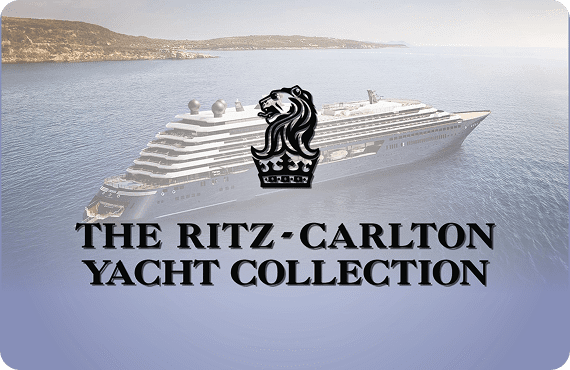Luxury yacht with The Ritz-Carlton Yacht Collection logo on water.