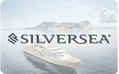 A luxury cruise ship sailing near a rocky coastline with the word 'SILVERSEA'.