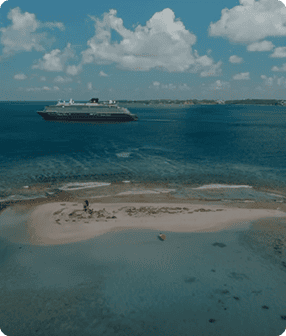 Cruise ship near small sandy island