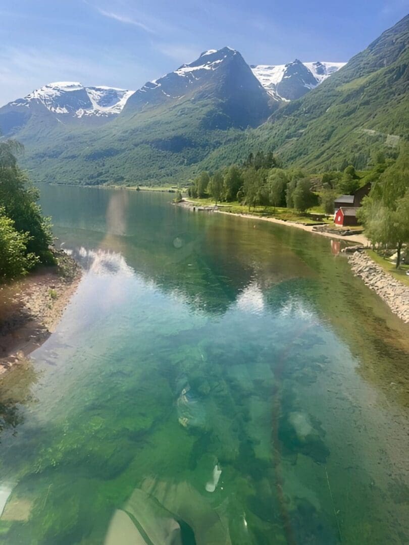 Mountain lake with clear water and snowcaps.